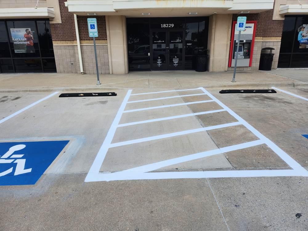 Van-accessible reserved parking signage and wheel stops