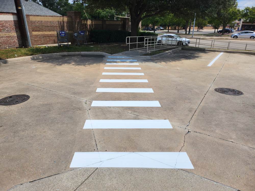 Crosswalk striping leading to an accessible ramp
